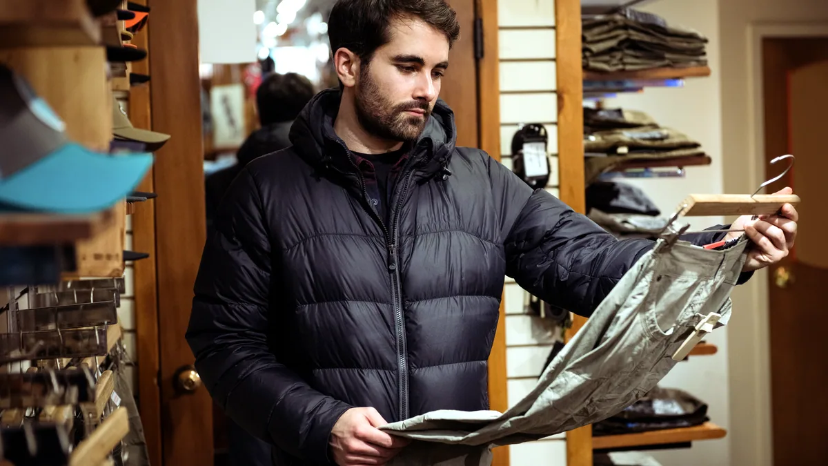 Merino base layers in a row of earth tones, displayed in an outdoor shop.