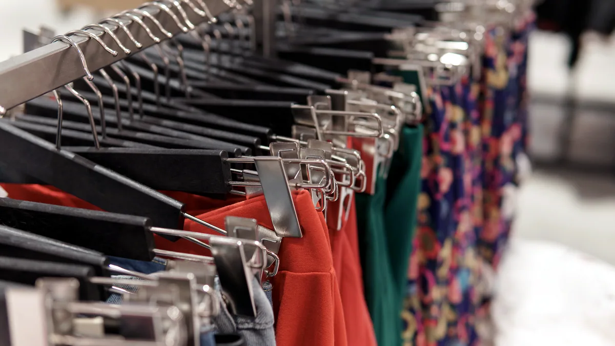 A clothing rail in a supermarket, with everyday winter wear hanging in a line.